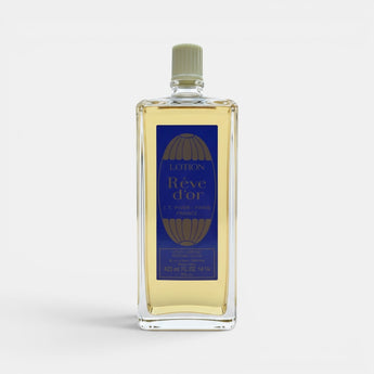 Galeries d'Orient Rêve d’or Eau de Cologne vaporisateur en verre transparent avec liquide doré, étiquette bleue et dorée.