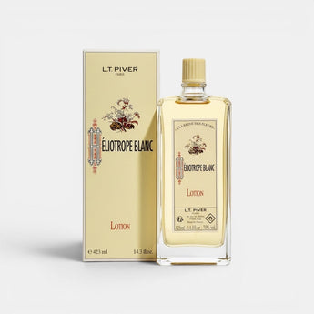 Galeries d'Orient : Lotion Héliotrope Blanc L.T. PIVER, flacon en verre transparent avec lotion dorée, packaging jaune orné de motifs floraux.
