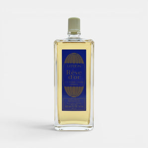Galeries d'Orient Rêve d’or Eau de Cologne vaporisateur en verre transparent avec liquide doré, étiquette bleue et dorée.